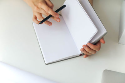 Midsection of woman using notebook