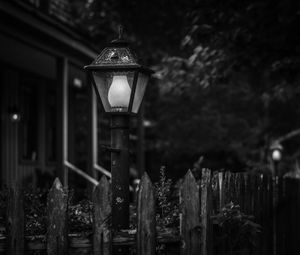 Close-up of illuminated lamp post at night