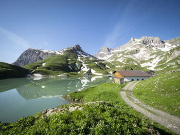 Scenic view of snowcapped mountains against clear sky