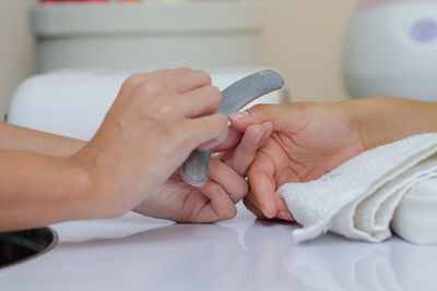 Midsection of couple holding hands