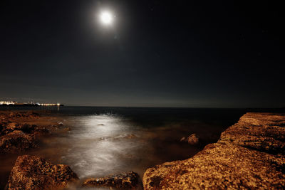 Scenic view of sea against sky at night