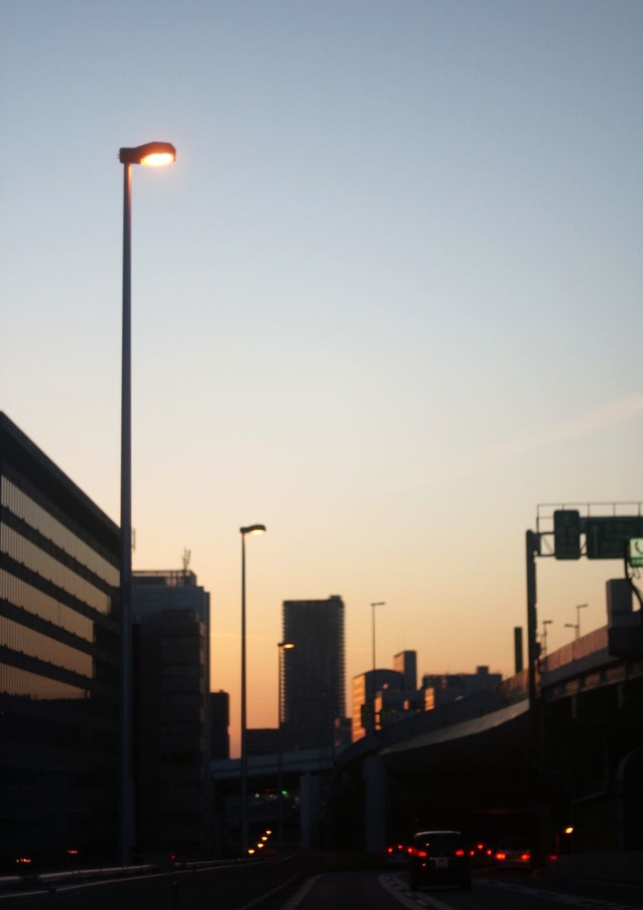 sky, sunset, street light, architecture, street, illuminated, lighting equipment, building exterior, built structure, city, transportation, car, no people, motor vehicle, dusk, mode of transportation, nature, clear sky, land vehicle, road, outdoors, office building exterior, light, cityscape, skyscraper