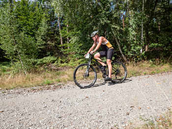 Man riding bicycle in forest