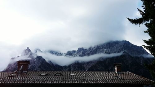 House roof against sky during winter