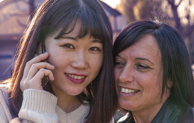 Close-up of colleague talking on phone outdoors