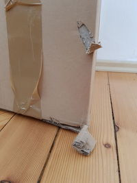 High angle view of paper on floor against wall at home