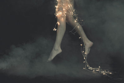 Close-up of illuminated lighting equipment against black background