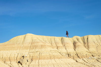 Man standing on desert against sky