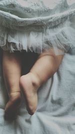 Low section of woman on bed