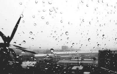 Full frame shot of wet glass window in rainy season