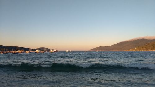 Scenic view of sea against clear sky during sunset