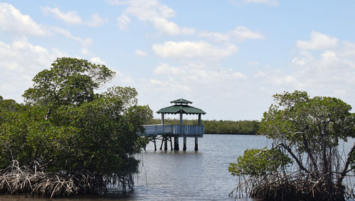 Built structure by trees against sky