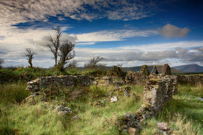 Abandoned built structure on field against sky