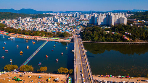 High angle view of city by buildings against sky