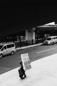 Side view of man walking on street in city