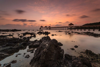 Scenic view of sea against romantic sky at sunset