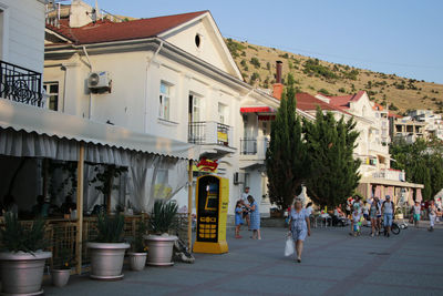 People on street amidst buildings in town