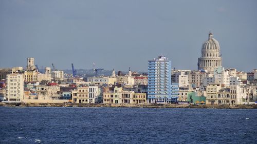 Buildings in city against clear sky