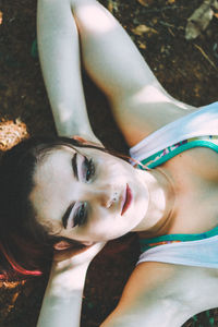 High angle view of woman lying on field at park