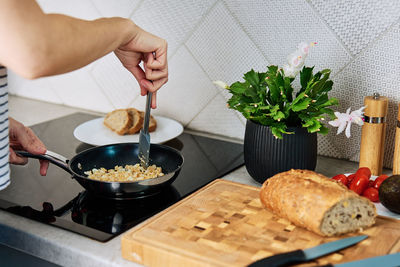 Woman cooking omelet , use induction stove and frying pan