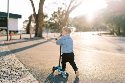 Full length of boy walking on footpath