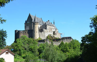 Low angle view of castle against clear blue sky