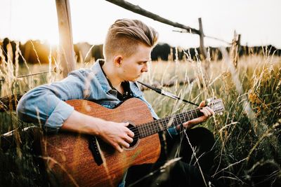 Man playing guitar on field