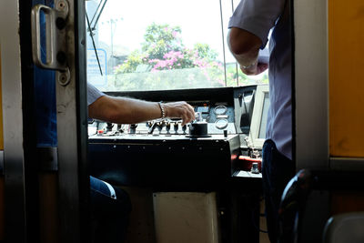 Cropped image of people in vehicle