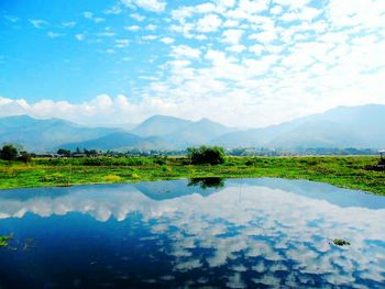 Scenic view of lake and mountains against sky