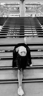 Full length of woman standing on staircase