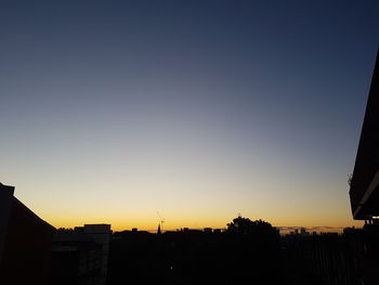 Silhouette of built structure against sky at sunset