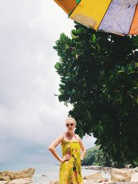 Woman standing by plants against sky