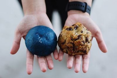 Cropped hand of person holding food