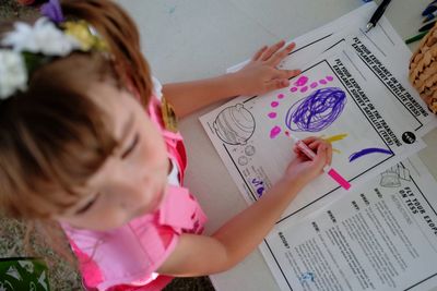 Low angle view of girl with arms raised