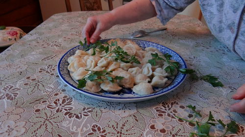 High angle view of man holding food on table