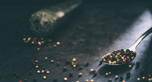 Close-up of peppercorns in spoon on table