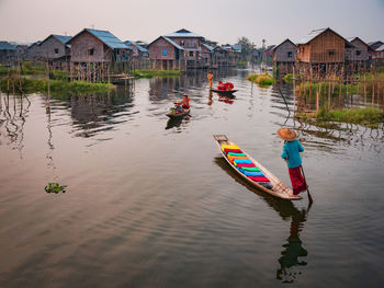 People on house by building