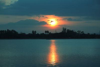 Scenic view of lake against romantic sky at sunset