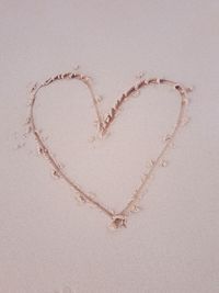 Directly above shot of heart shape on sand