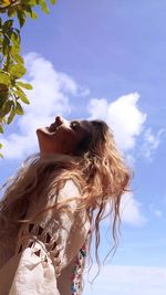 Low angle view of woman against sky