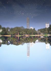 Reflection of trees in lake against clear sky