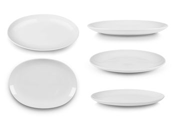 Directly above shot of ceramic plates against white background