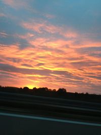 Scenic view of landscape against sky at sunset