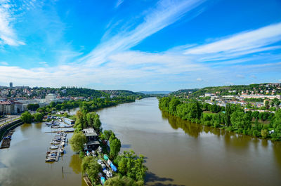 River amidst buildings in city against sky