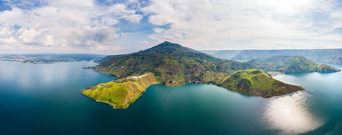 Scenic view of lake and mountains against sky