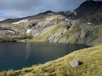 Scenic view of lake and mountains against sky