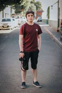 Portrait of teenage boy standing on road