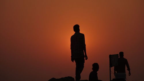 Silhouette of man standing at sunset