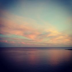 Scenic view of sea against sky at sunset