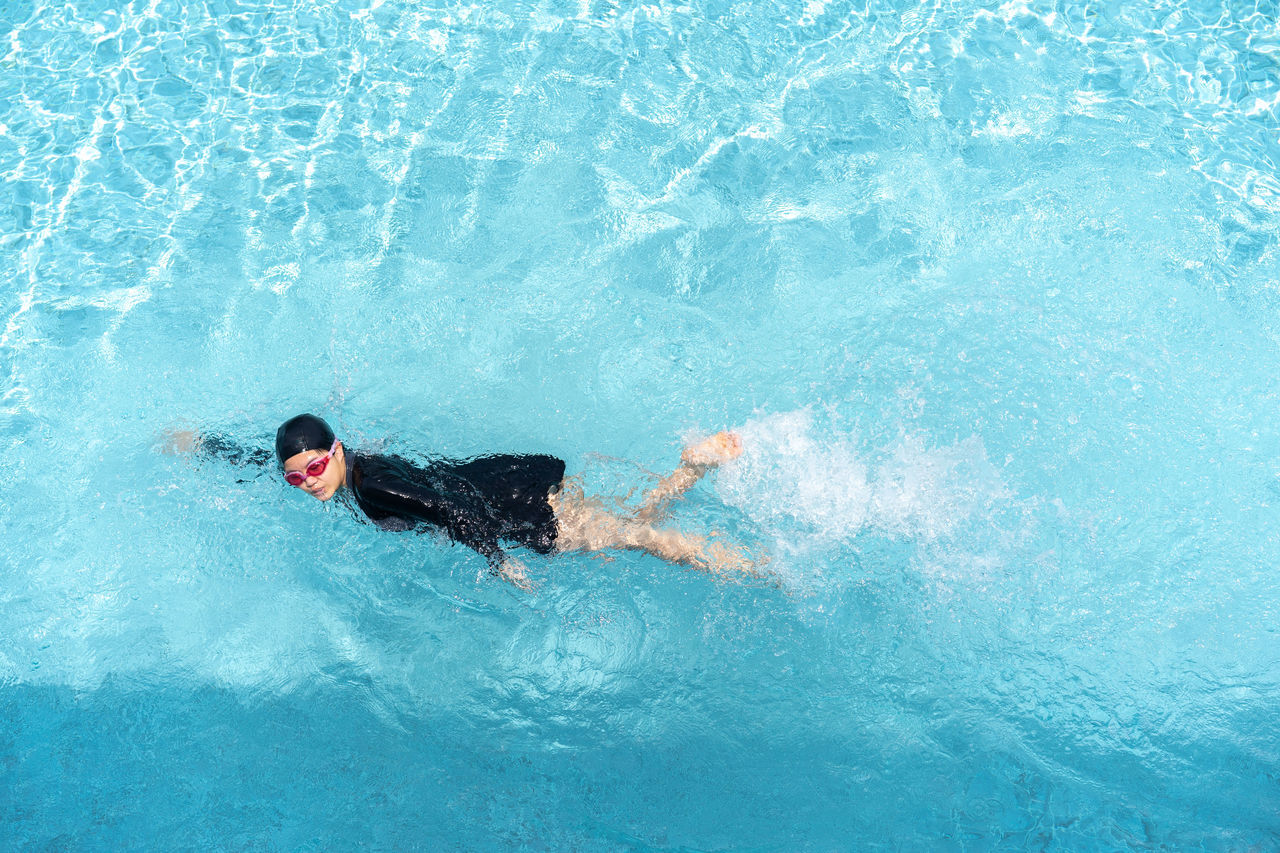 MAN SWIMMING IN POOL